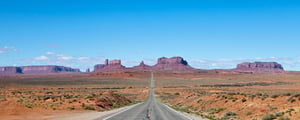 road-passing-through-a-barren-desert-landscape-2022-03-04-02-39-14-utc