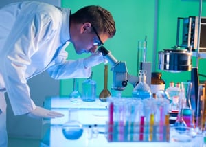 scientist looking into a microscope