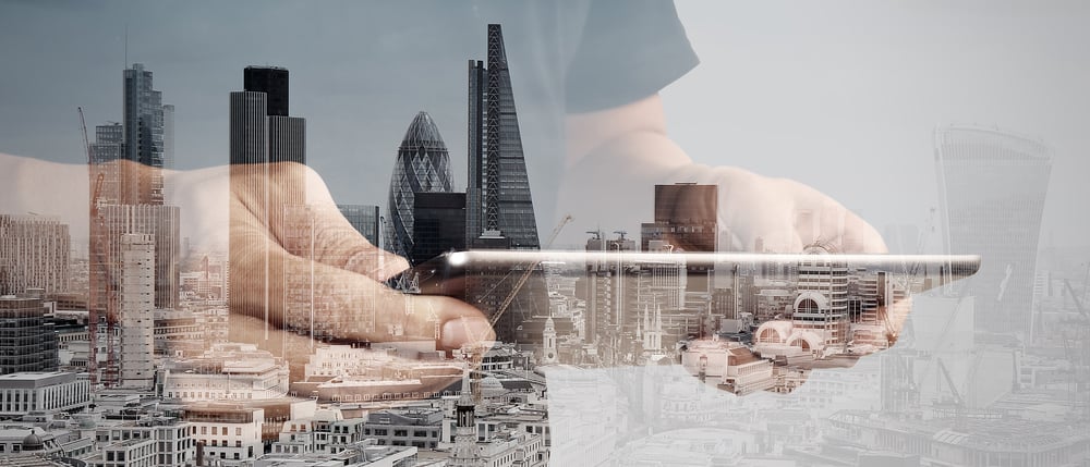 Double exposure of success businessman using digital tablet with london building and social media diagram